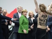 Topless Femen activists rush at Putin and Merkel