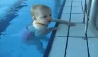 1 year and 9 months old baby swims in the pool