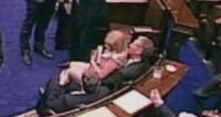 Irish MP pulls female colleague onto his lap